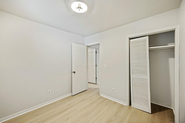 unfurnished bedroom featuring a closet and light hardwood / wood-style flooring