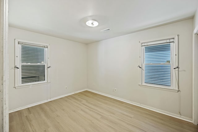 unfurnished room with light hardwood / wood-style flooring