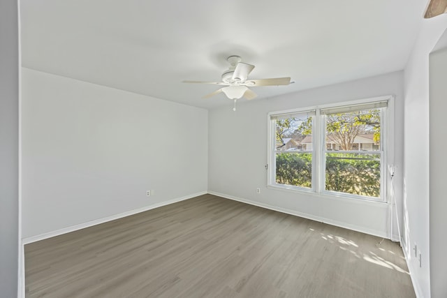 unfurnished room featuring ceiling fan and hardwood / wood-style floors