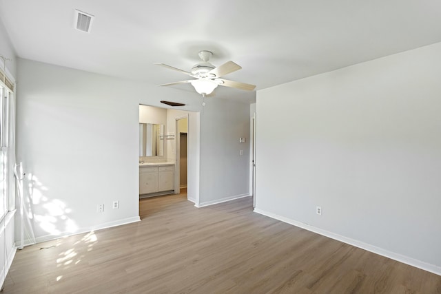 unfurnished room featuring ceiling fan and light wood-type flooring