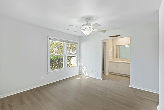 unfurnished room featuring sink, light hardwood / wood-style flooring, and ceiling fan