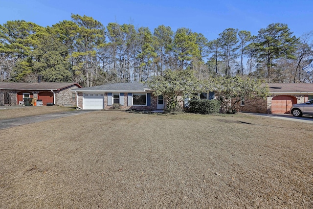 single story home with a garage and a front yard