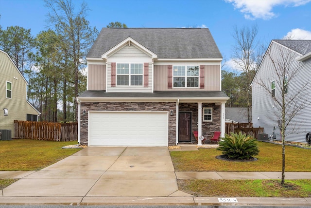 view of front of home featuring a front lawn, concrete driveway, fence, and board and batten siding