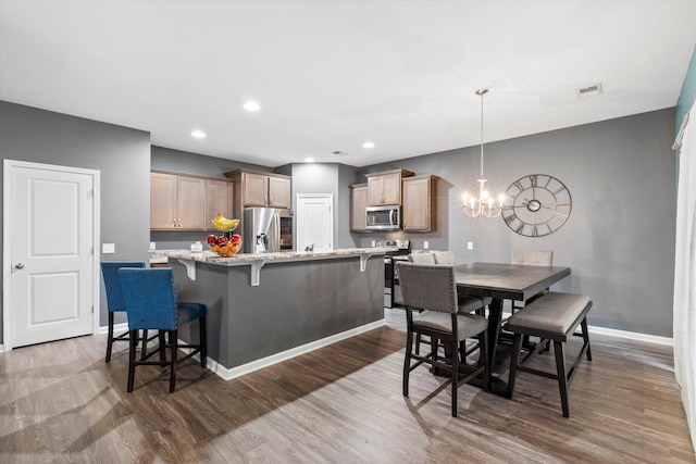 dining area with visible vents, baseboards, dark wood finished floors, recessed lighting, and a notable chandelier