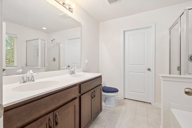 bathroom with tile patterned floors, a stall shower, double vanity, and a sink