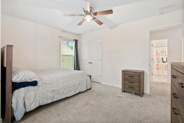 bedroom featuring carpet, visible vents, baseboards, ceiling fan, and a closet