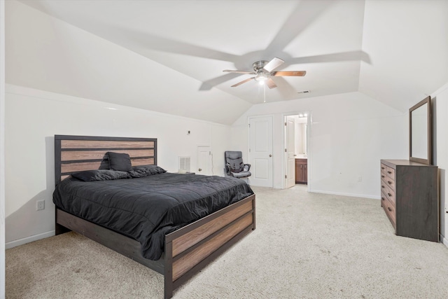 bedroom with vaulted ceiling, light colored carpet, and visible vents