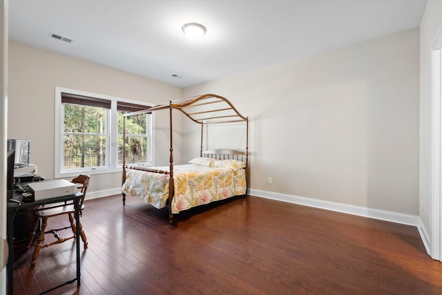 bedroom featuring dark wood-type flooring, visible vents, and baseboards