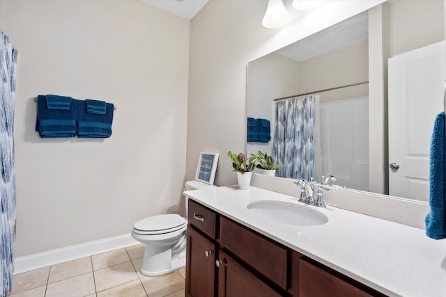 bathroom featuring baseboards, toilet, a shower with curtain, tile patterned floors, and vanity