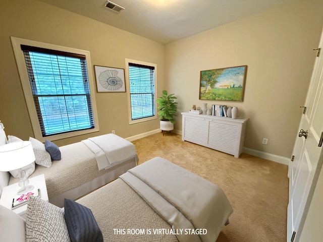 carpeted bedroom featuring visible vents and baseboards