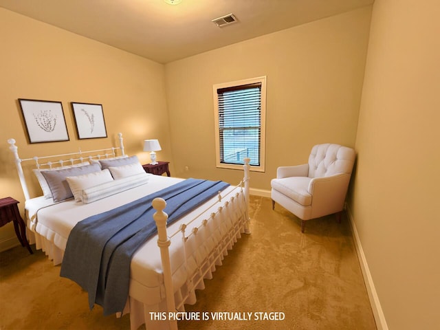 bedroom featuring baseboards, visible vents, and carpet flooring