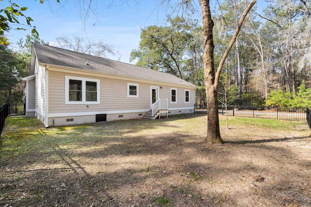 rear view of property featuring crawl space, roof with shingles, fence, and entry steps