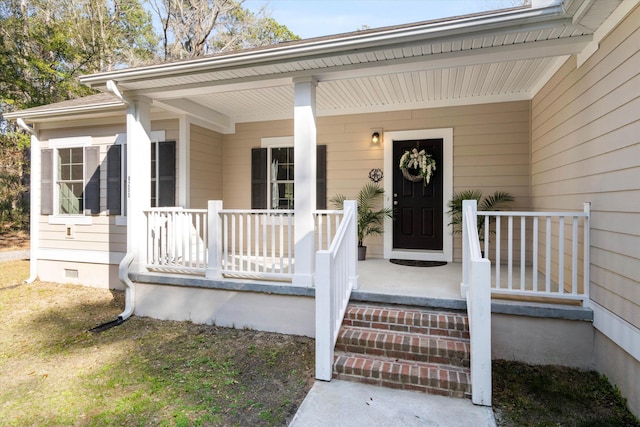 entrance to property featuring covered porch and crawl space