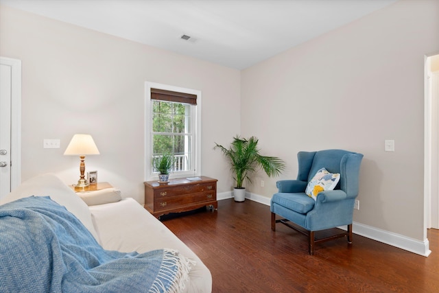 sitting room featuring wood finished floors, visible vents, and baseboards