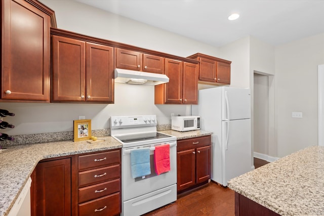 kitchen featuring light stone counters, dark wood-style flooring, recessed lighting, white appliances, and under cabinet range hood