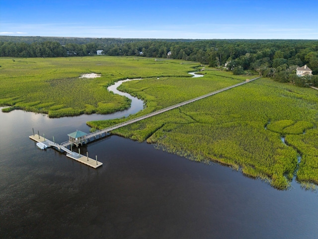 drone / aerial view featuring a water view and a forest view