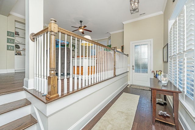 stairway featuring hardwood / wood-style flooring, plenty of natural light, and ornamental molding