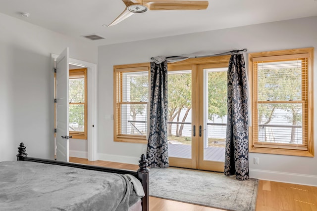 bedroom featuring ceiling fan, light wood-type flooring, access to outside, and multiple windows