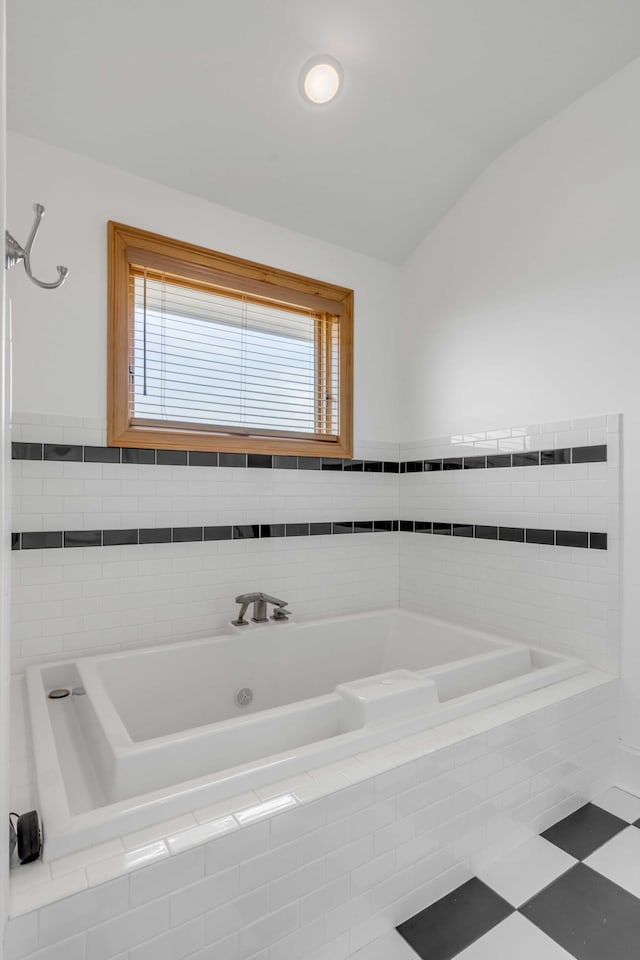 bathroom with a relaxing tiled tub