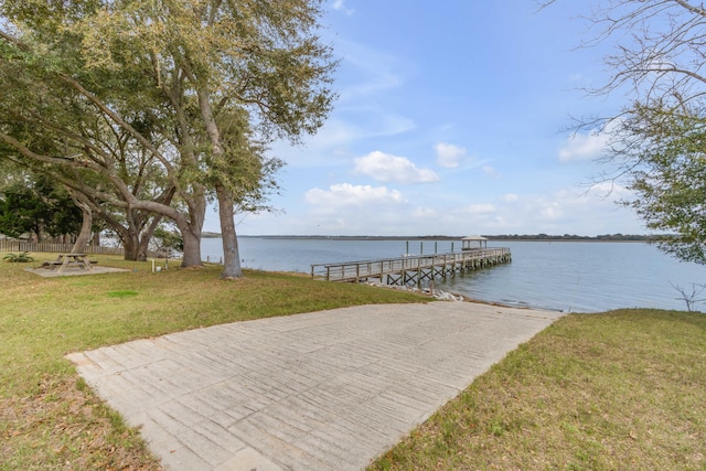 dock area featuring a yard and a water view