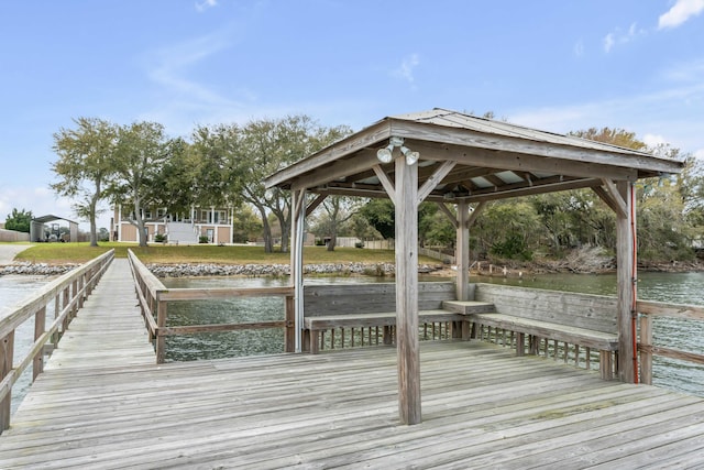 view of dock featuring a gazebo and a water view