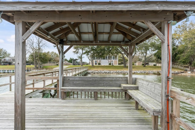 view of dock with a gazebo and a water view