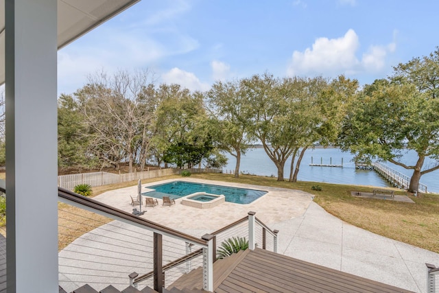 view of pool featuring an in ground hot tub, a yard, a water view, and a patio area