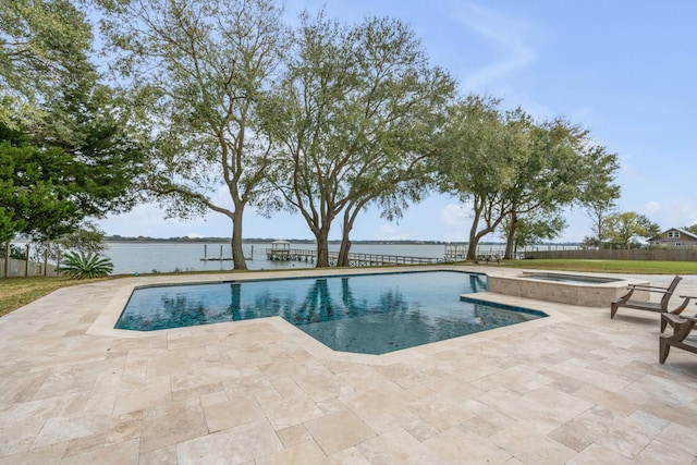 view of swimming pool featuring a water view, a patio, and an in ground hot tub