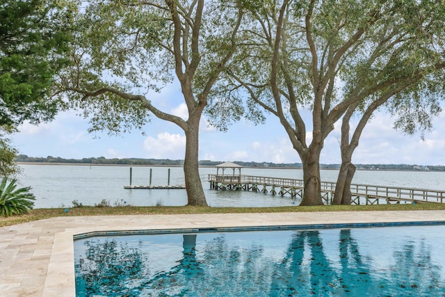 view of swimming pool with a water view