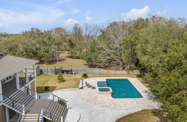 view of pool featuring an in ground hot tub, a yard, and a patio