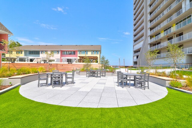 view of home's community with a yard and a patio area