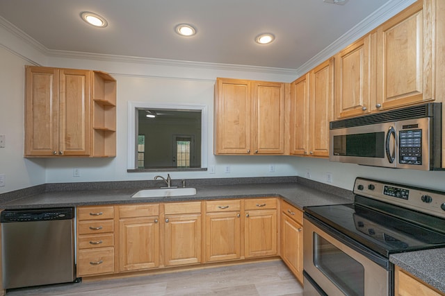 kitchen with crown molding, dark countertops, appliances with stainless steel finishes, a sink, and recessed lighting