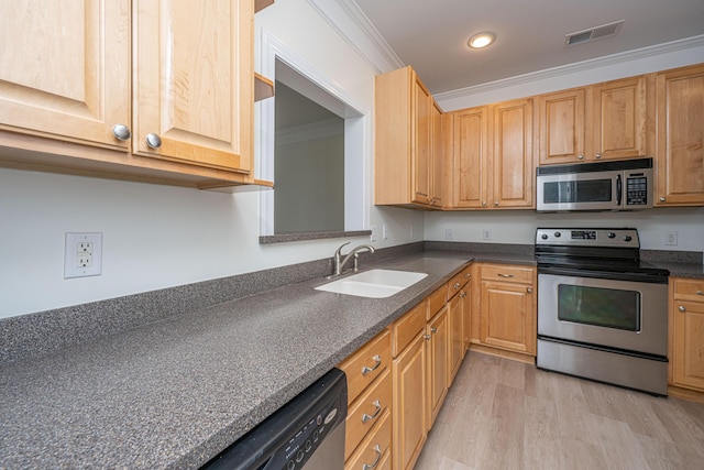 kitchen with visible vents, appliances with stainless steel finishes, dark countertops, a sink, and light wood-style floors