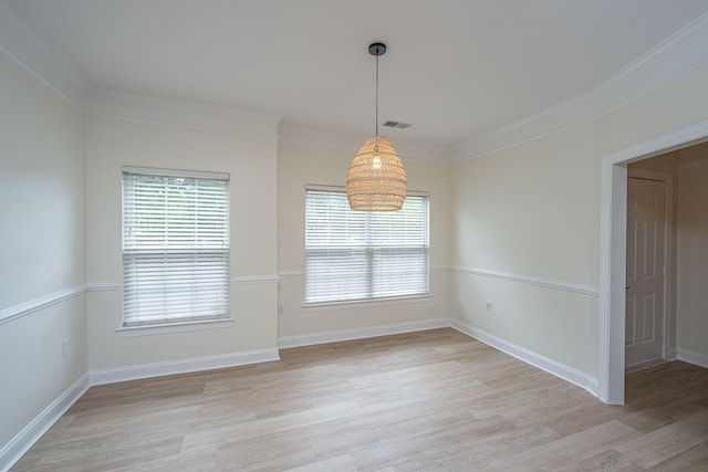 unfurnished dining area with baseboards, ornamental molding, and light wood-style flooring