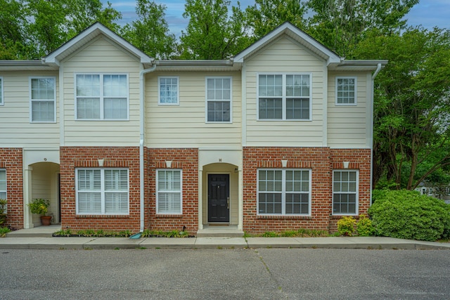 view of property featuring brick siding