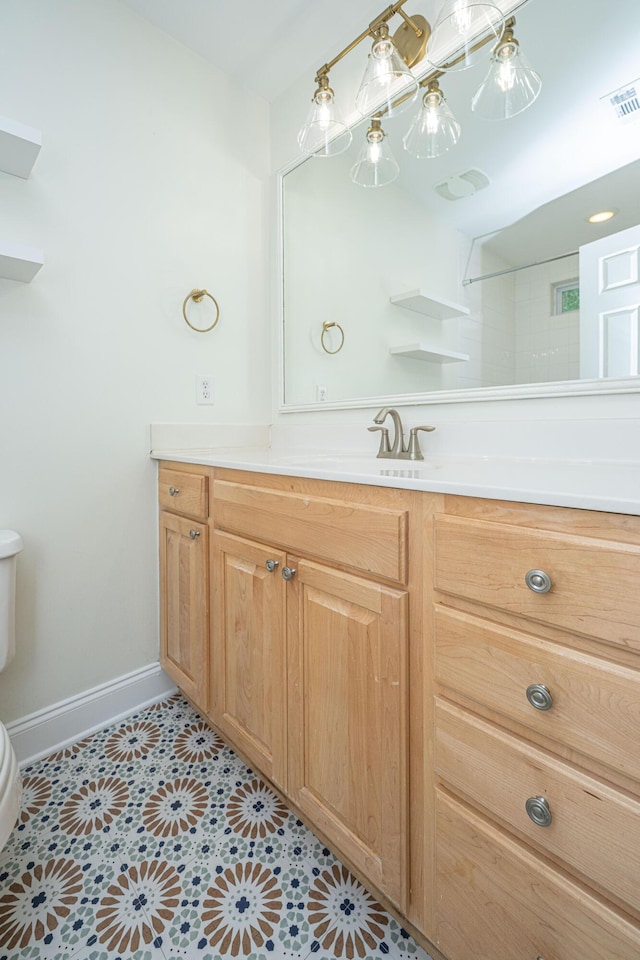 bathroom with tile patterned flooring, visible vents, vanity, toilet, and baseboards