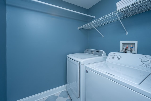 laundry room featuring laundry area, washer and clothes dryer, and baseboards