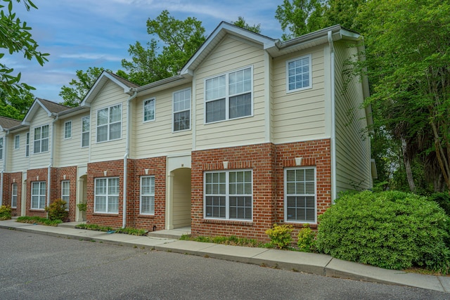 townhome / multi-family property featuring brick siding