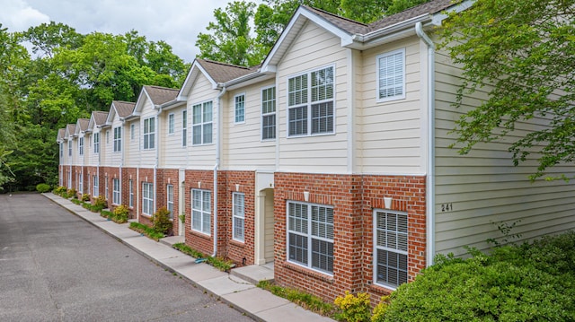 view of side of property with brick siding