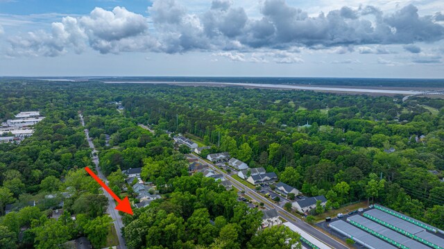 birds eye view of property featuring a forest view