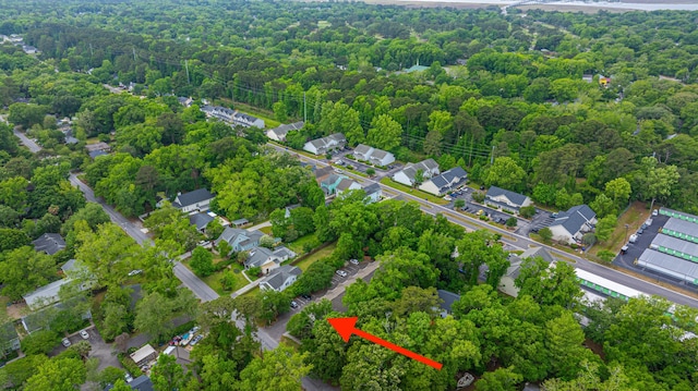 birds eye view of property featuring a view of trees and a residential view