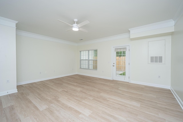 empty room with visible vents, ornamental molding, light wood-style floors, baseboards, and a ceiling fan