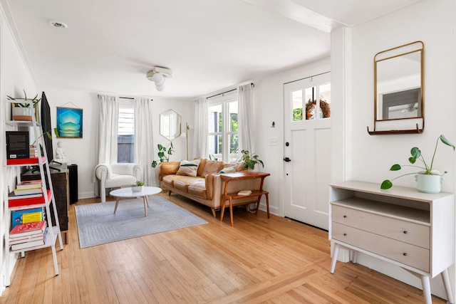 living area with light wood finished floors and baseboards