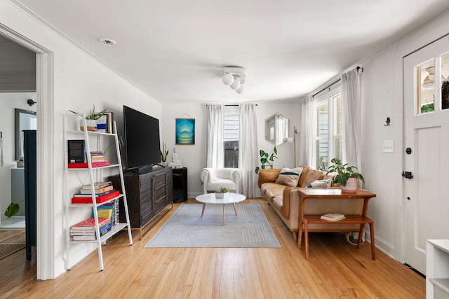 living room featuring light wood-type flooring and baseboards