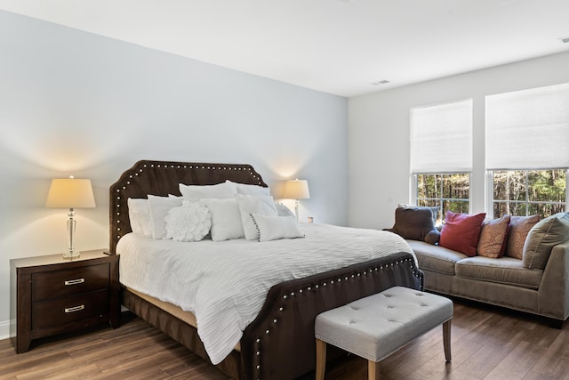 bedroom featuring visible vents and wood finished floors