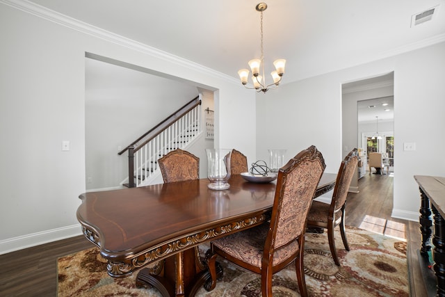 dining room featuring stairs, an inviting chandelier, wood finished floors, and visible vents