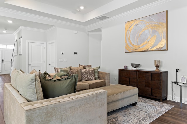 living room with visible vents, a tray ceiling, recessed lighting, dark wood-style flooring, and ornamental molding