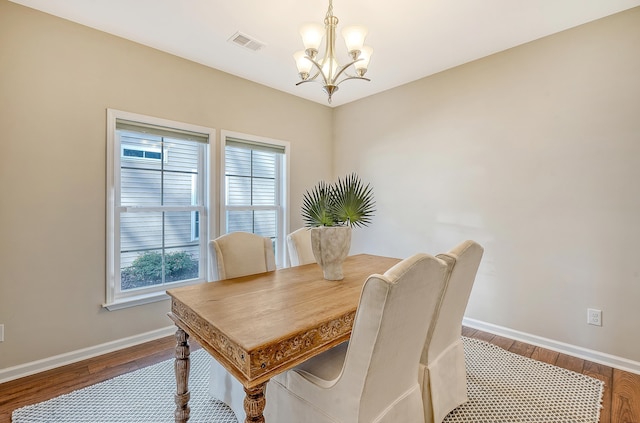 dining room featuring hardwood / wood-style floors, an inviting chandelier, and a wealth of natural light