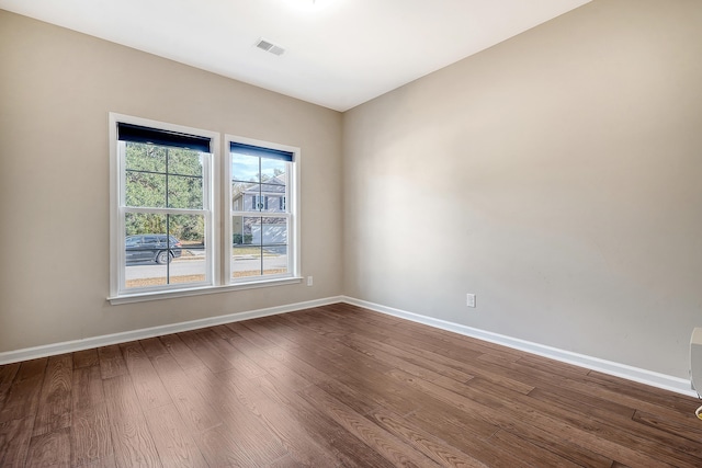 unfurnished room with hardwood / wood-style flooring