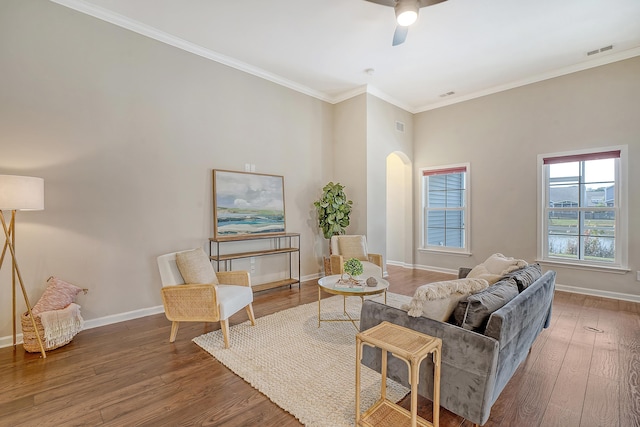 living room with crown molding, hardwood / wood-style floors, and ceiling fan